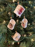 Christmas ornaments in the shape of a mini luminaria.